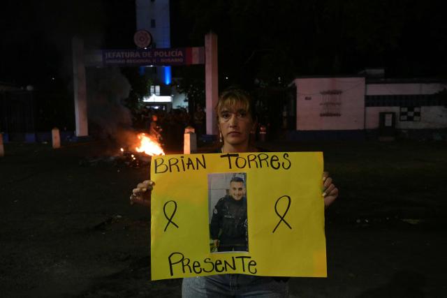 The mother of late Argentine police officer Brian Torres takes part in a police protest demanding better salaries and labor conditions in Rosario, Santa Fe province, Argentina early on February 11, 2026. Several dozen Argentine police officers rebelled in demand of better pay and mental health care in the city of Rosario, the country's most crime-ridden city, in protests that continued into the night of February 10, 2026, after escalating the previous day. (Photo by Juan MABROMATA / AFP)