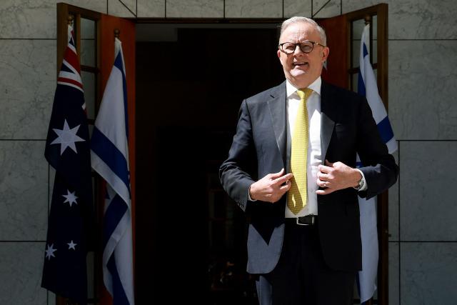 Australia's Prime Minister Anthony Albanese waits to receive Israel's President Isaac Herzog at the Parliament House in Canberra on February 11, 2026. Herzog's tightly secured, four-day trip aims to console Australia's Jewish community after the December shooting at Sydney's Bondi Beach that killed 15 people at a Hanukkah festival. (Photo by DAVID GRAY / AFP)