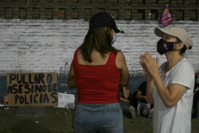 A sign that reads "Pullaro, murderer of police officers", in reference to Santa Fe governor Maximiliano Pullaro, is seen during a police protest demanding better salaries and labor conditions in Rosario, Santa Fe province, Argentina early on February 11, 2026. Several dozen Argentine police officers rebelled in demand of better pay and mental health care in the city of Rosario, the country's most crime-ridden city, in protests that continued into the night of February 10, 2026, after escalating the previous day. (Photo by Juan MABROMATA / AFP)