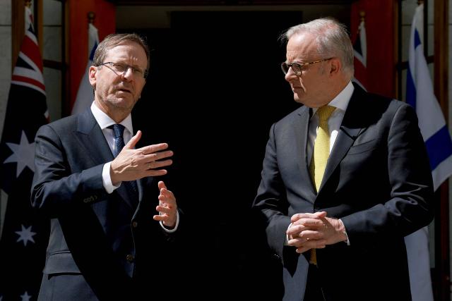 Australia's Prime Minister Anthony Albanese (R) receives Israel's President Isaac Herzog at the Parliament House in Canberra on February 11, 2026. Herzog's tightly secured, four-day trip aims to console Australia's Jewish community after the December shooting at Sydney's Bondi Beach that killed 15 people at a Hanukkah festival. (Photo by DAVID GRAY / AFP)