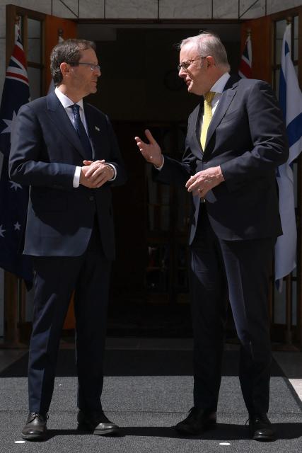 Australia's Prime Minister Anthony Albanese (R) receives Israel's President Isaac Herzog at the Parliament House in Canberra on February 11, 2026. Herzog's tightly secured, four-day trip aims to console Australia's Jewish community after the December shooting at Sydney's Bondi Beach that killed 15 people at a Hanukkah festival. (Photo by DAVID GRAY / AFP)
