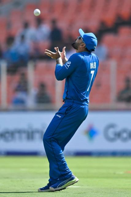 Afghanistan's Mohammad Nabi takes a catch to dismiss South Africa's captain Aiden Markram during the 2026 ICC Men's T20 Cricket World Cup group stage match between Afghanistan and South Africa at the Narendra Modi Stadium in Ahmedabad on February 11, 2026. (Photo by Shammi MEHRA / AFP)
