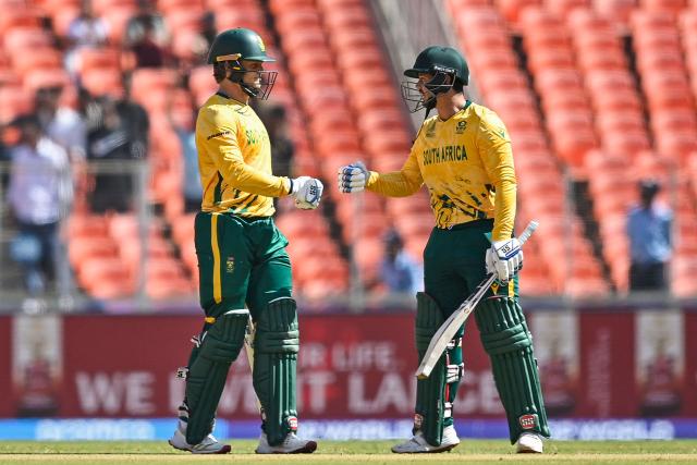 South Africa's Ryan Rickelton (L) and Quinton de Kock bump their fists during the 2026 ICC Men's T20 Cricket World Cup group stage match between Afghanistan and South Africa at the Narendra Modi Stadium in Ahmedabad on February 11, 2026. (Photo by Shammi MEHRA / AFP)