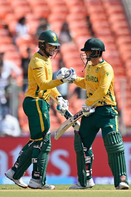 South Africa's Ryan Rickelton (L) and Quinton de Kock gesture during the 2026 ICC Men's T20 Cricket World Cup group stage match between Afghanistan and South Africa at the Narendra Modi Stadium in Ahmedabad on February 11, 2026. (Photo by Shammi MEHRA / AFP)