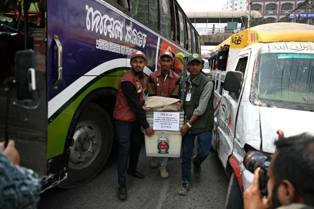 Election officials carry ballot boxes bieng dispatched to polling stations in Dhaka on February 11, 2026 ahead of Bangladesh's general elections. (Photo by MOHD RASFAN / AFP)