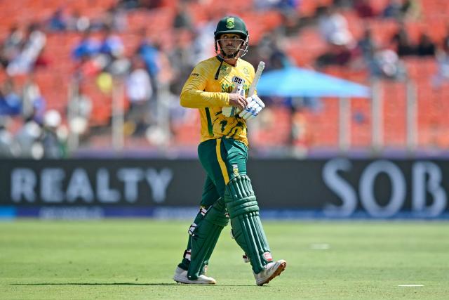 South Africa's Quinton de Kock walks back to the pavilion after his dismissal during the 2026 ICC Men's T20 Cricket World Cup group stage match between Afghanistan and South Africa at the Narendra Modi Stadium in Ahmedabad on February 11, 2026. (Photo by Shammi MEHRA / AFP)