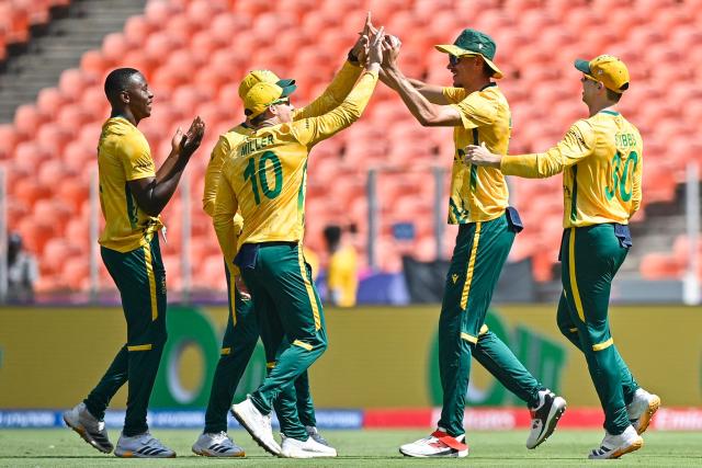 South Africa's Marco Jansen (2R) celebrates with Kagiso Rabada (L), David Miller (2L) and Tristan Stubbs after taking a catch to dismiss Afghanistan's Sediqullah Atal during the 2026 ICC Men's T20 Cricket World Cup group stage match between Afghanistan and South Africa at the Narendra Modi Stadium in Ahmedabad on February 11, 2026. (Photo by Shammi MEHRA / AFP)
