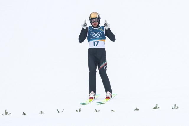 Italy's Aaron Kostner lands after jumping during the ski jumping trial round of the nordic combined individual Gundersen normal hill/10km event at Predazzo Ski Jumping Stadium in Predazzo (Val di Fiemme) during the Milano Cortina 2026 Winter Olympic Games on February 11, 2026. (Photo by Anne-Christine POUJOULAT / AFP)