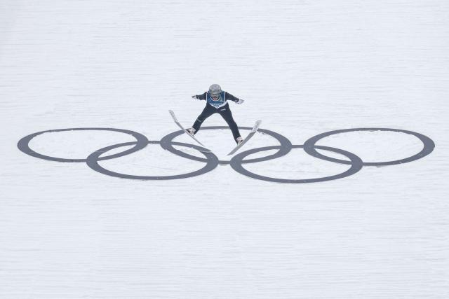 France's Marco Heinis jumps during the ski jumping trial round of the nordic combined individual Gundersen normal hill/10km event at Predazzo Ski Jumping Stadium in Predazzo (Val di Fiemme) during the Milano Cortina 2026 Winter Olympic Games on February 11, 2026. (Photo by Anne-Christine POUJOULAT / AFP)