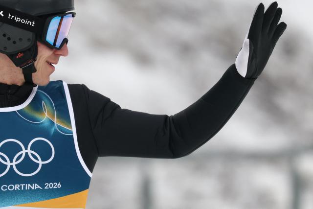 France's Laurent Muhlethaler reacts after jumping during the ski jumping trial round of the nordic combined individual Gundersen normal hill/10km event at Predazzo Ski Jumping Stadium in Predazzo (Val di Fiemme) during the Milano Cortina 2026 Winter Olympic Games on February 11, 2026. (Photo by Anne-Christine POUJOULAT / AFP)