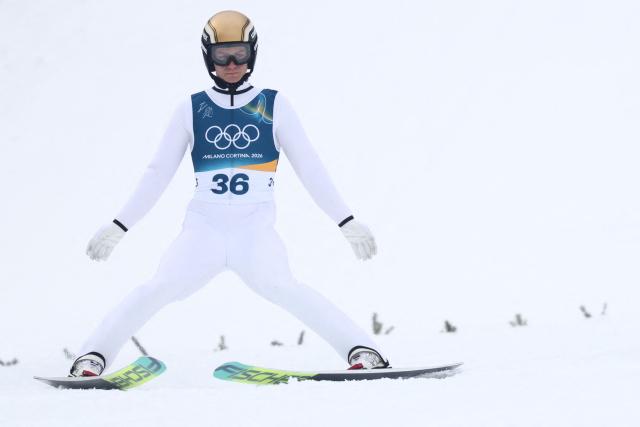 Austria's Johannes Lamparter lands after jumping during the ski jumping trial round of the nordic combined individual Gundersen normal hill/10km event at Predazzo Ski Jumping Stadium in Predazzo (Val di Fiemme) during the Milano Cortina 2026 Winter Olympic Games on February 11, 2026. (Photo by Anne-Christine POUJOULAT / AFP)