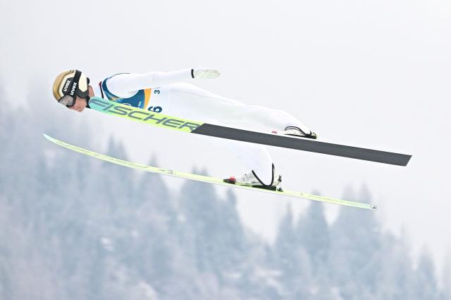 Austria's Johannes Lamparter jumps during the ski jumping trial round of the nordic combined individual Gundersen normal hill/10km event at Predazzo Ski Jumping Stadium in Predazzo (Val di Fiemme) during the Milano Cortina 2026 Winter Olympic Games on February 11, 2026. (Photo by Tobias SCHWARZ / AFP)