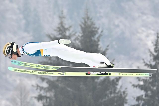 Austria's Johannes Lamparter jumps during the ski jumping trial round of the nordic combined individual Gundersen normal hill/10km event at Predazzo Ski Jumping Stadium in Predazzo (Val di Fiemme) during the Milano Cortina 2026 Winter Olympic Games on February 11, 2026. (Photo by Tobias SCHWARZ / AFP)