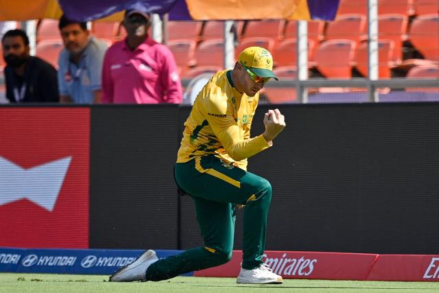 South Africa's David Miller takes a catch to dismiss Afghanistan's captain Rashid Khan during the 2026 ICC Men's T20 Cricket World Cup group stage match between Afghanistan and South Africa at the Narendra Modi Stadium in Ahmedabad on February 11, 2026. (Photo by Shammi MEHRA / AFP)