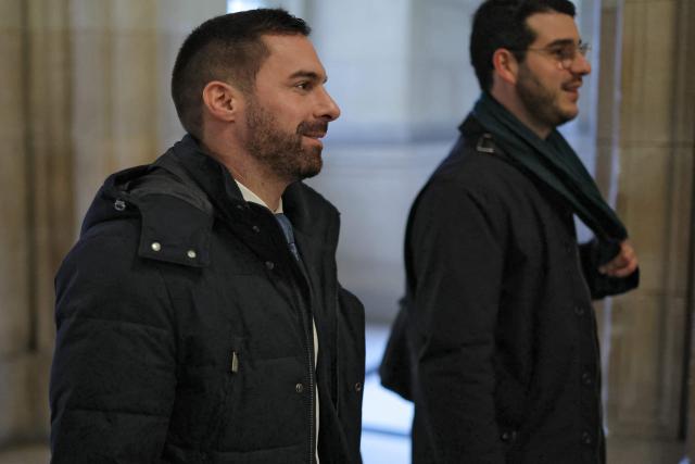 Rassemblement National's MP Julien Odoul arrives to attend a hearing of the appeal trial of far-right party Rassemblement National (RN) former or actual members on charges of embezzlement of European public funds in a case of alleged European Parliament fake jobs at the Palais de Justice in Paris, on February 11, 2026. (Photo by Thomas SAMSON / AFP)