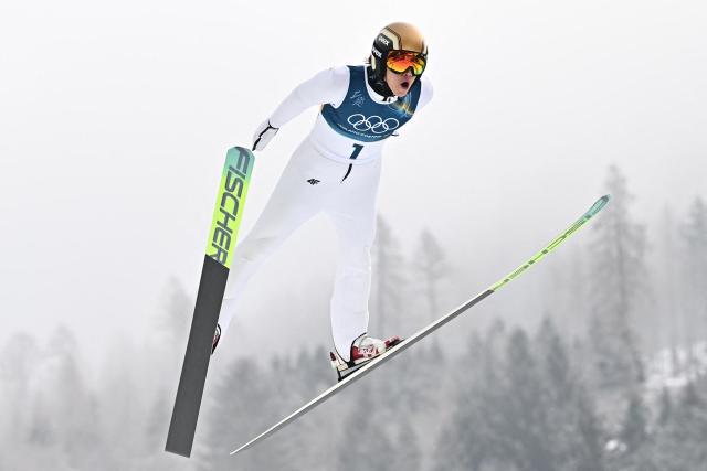 Poland's Kacper Jarzabek jumps in the competition round of the ski jumping of the nordic combined individual Gundersen normal hill/10km event at Predazzo Ski Jumping Stadium in Predazzo (Val di Fiemme) during the Milano Cortina 2026 Winter Olympic Games on February 11, 2026. (Photo by Javier SORIANO / AFP)