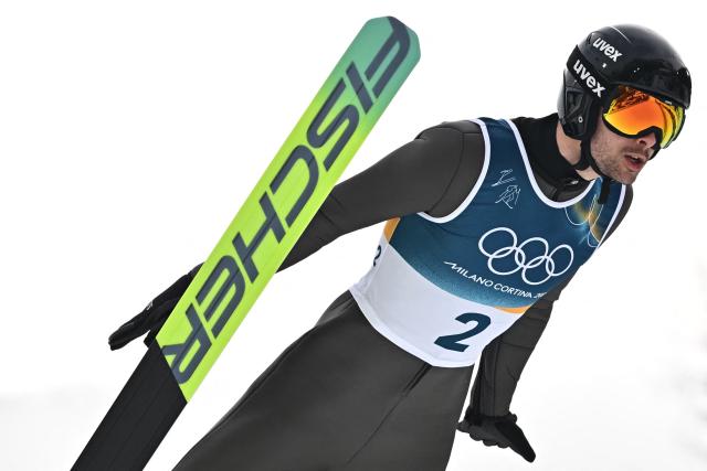 Ukraine's Oleksandr Shumbarets jumps in the competition round of the ski jumping of the nordic combined individual Gundersen normal hill/10km event at Predazzo Ski Jumping Stadium in Predazzo (Val di Fiemme) during the Milano Cortina 2026 Winter Olympic Games on February 11, 2026. (Photo by Javier SORIANO / AFP)