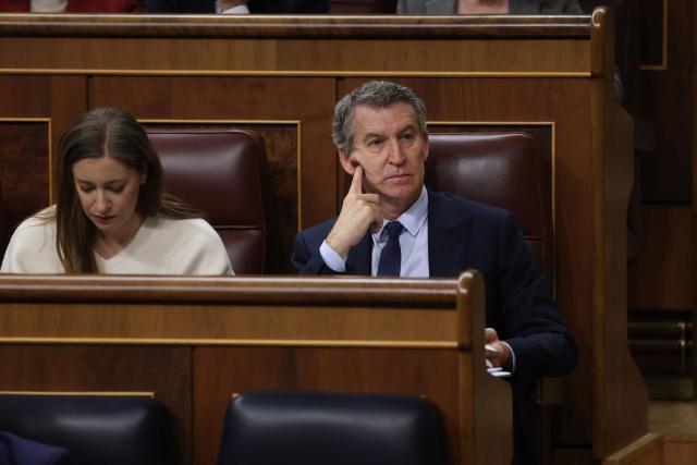 Spain's opposition Popular Party (PP) leader Alberto Nunez Feijoo looks on next to PP's national secretary for health and education Esther Munoz after Spain's Prime minister address over January train tragedy at the congress in Madrid on February 11, 2026. Two train accidents raised questions about Spanish rail safety. The collision of two high-speed trains in the southern region of Andalusia claimed 46 lives and a regional train accident in Catalunya killed one last month. (Photo by Pierre-Philippe MARCOU / AFP)