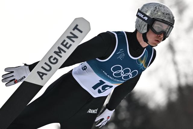France's Marco Heinis jumps in the competition round of the ski jumping of the nordic combined individual Gundersen normal hill/10km event at Predazzo Ski Jumping Stadium in Predazzo (Val di Fiemme) during the Milano Cortina 2026 Winter Olympic Games on February 11, 2026. (Photo by Javier SORIANO / AFP)