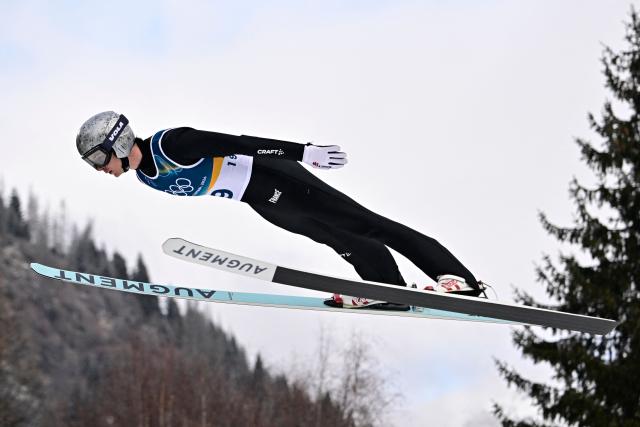 France's Marco Heinis jumps in the competition round of the ski jumping of the nordic combined individual Gundersen normal hill/10km event at Predazzo Ski Jumping Stadium in Predazzo (Val di Fiemme) during the Milano Cortina 2026 Winter Olympic Games on February 11, 2026. (Photo by Tobias SCHWARZ / AFP)