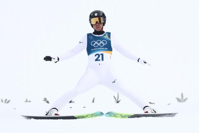 Japan's Akito Watabe lands after jumping in the competition round of the ski jumping of the nordic combined individual Gundersen normal hill/10km event at Predazzo Ski Jumping Stadium in Predazzo (Val di Fiemme) during the Milano Cortina 2026 Winter Olympic Games on February 11, 2026. (Photo by Anne-Christine POUJOULAT / AFP)