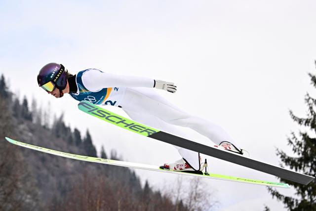 USA's Niklas Malacinski jumps in the competition round of the ski jumping of the nordic combined individual Gundersen normal hill/10km event at Predazzo Ski Jumping Stadium in Predazzo (Val di Fiemme) during the Milano Cortina 2026 Winter Olympic Games on February 11, 2026. (Photo by Tobias SCHWARZ / AFP)