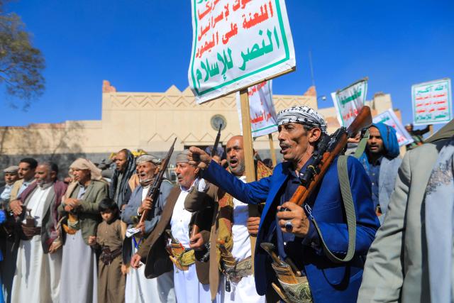 Protesters shout anti-US and anti-Israeli slogans during a demonstration outside the former US embassy building in the Huthi-controlled capital Sanaa on February 11, 2026, marking the anniversary of the US withdrawal from the country in 2015. (Photo by Ahmed Mohammed / AFP)