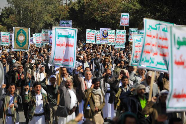 Protesters shout anti-US and anti-Israeli slogans during a demonstration outside the former US embassy building in the Huthi-controlled capital Sanaa on February 11, 2026, marking the anniversary of the US withdrawal from the country in 2015. (Photo by Ahmed Mohammed / AFP)