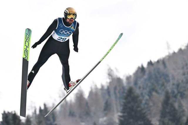 Germany's Johannes Rydzek jumps in the competition round of the ski jumping of the nordic combined individual Gundersen normal hill/10km event at Predazzo Ski Jumping Stadium in Predazzo (Val di Fiemme) during the Milano Cortina 2026 Winter Olympic Games on February 11, 2026. (Photo by Javier SORIANO / AFP)