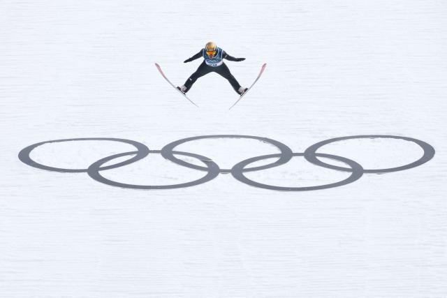 Germany's Vinzenz Geiger jumps in the competition round of the ski jumping of the nordic combined individual Gundersen normal hill/10km event at Predazzo Ski Jumping Stadium in Predazzo (Val di Fiemme) during the Milano Cortina 2026 Winter Olympic Games on February 11, 2026. (Photo by Anne-Christine POUJOULAT / AFP)