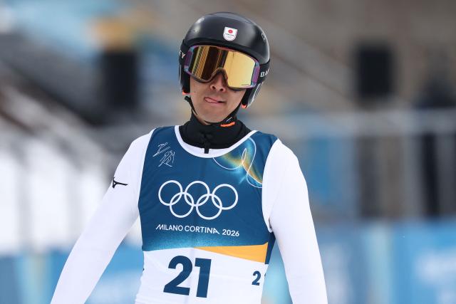 Japan's Akito Watabe reacts after jumping in the competition round of the ski jumping of the nordic combined individual Gundersen normal hill/10km event at Predazzo Ski Jumping Stadium in Predazzo (Val di Fiemme) during the Milano Cortina 2026 Winter Olympic Games on February 11, 2026. (Photo by Anne-Christine POUJOULAT / AFP)