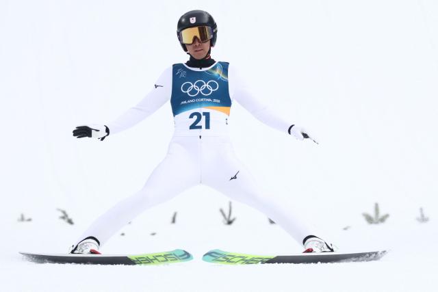 Japan's Akito Watabe lands after jumping in the competition round of the ski jumping of the nordic combined individual Gundersen normal hill/10km event at Predazzo Ski Jumping Stadium in Predazzo (Val di Fiemme) during the Milano Cortina 2026 Winter Olympic Games on February 11, 2026. (Photo by Anne-Christine POUJOULAT / AFP)