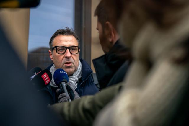 Fabrizio Ventimiglia, lawyer for some of the victims speaks to the press as he arrives for a hearing at the Office of the public prosecutor of the Canton of Valais as part of the inquiry into a devastating New Year's fire, in Sion on February 11, 2026. 41 people, most of them teenagers, were killed, while 115 were injured in a fire that ripped through in Le Constellation bar in the Alpine ski resort of Crans-Montana on New Year's Eve. (Photo by Loic Micheloud / AFP)