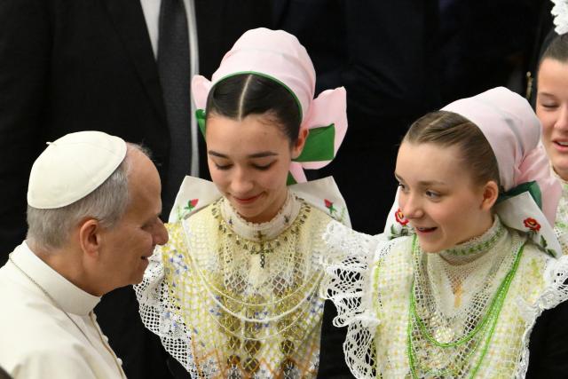 Pope Leo XIV greets German girls wearing traditional clothes at the end of his weekly general audience at the Paul VI hall in the Vatican on February 11, 2026. (Photo by Alberto PIZZOLI / AFP)