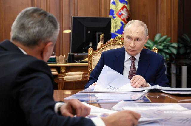 In this pool photograph distributed by the Russian state agency Sputnik, Russia's President Vladimir Putin attends a meeting with the head of North Ossetia in Moscow on February 11, 2026. (Photo by Vyacheslav PROKOFYEV / POOL / AFP)