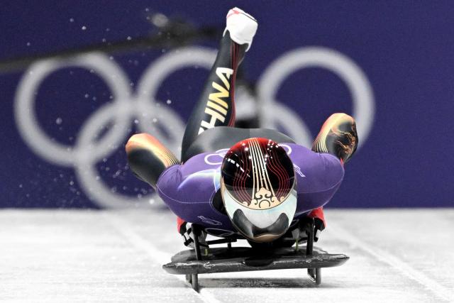 China's Chen Wenhao takes part in the skeleton men's training session at Cortina Sliding Centre during the Milano Cortina 2026 Winter Olympic Games in Cortina d'Ampezzo on February 11, 2026. (Photo by Tiziana FABI / AFP)