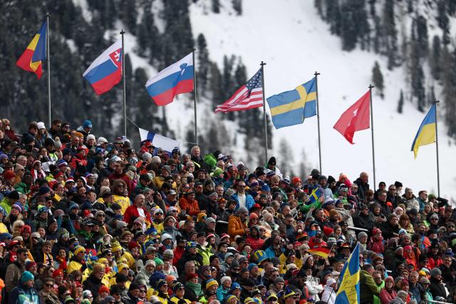 Spectators gather to watch the women's biathlon 15km individual event during the Milano Cortina 2026 Winter Olympic Games at the Anterselva Biathlon Arena (Sudtirol Arena) in Anterselva (Val Pusteria) on February 11, 2026. (Photo by FRANCK FIFE / AFP)