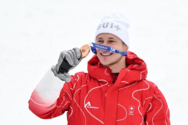 Bronze medallist Switzerland's Marco Odermatt poses  on the podium of the men's super-G alpine skiing event during the Milano Cortina 2026 Winter Olympic Games at the Stelvio Ski Centre in Bormio (Valtellina) on February 11, 2026. (Photo by Fabrice COFFRINI / AFP)