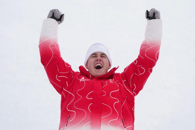 Switzerland's gold medalist Franjo von Allmen celebrates on the podium of the men's super-G alpine skiing event during the Milano Cortina 2026 Winter Olympic Games at the Stelvio Ski Centre in Bormio (Valtellina) on February 11, 2026. (Photo by Dimitar DILKOFF / AFP)