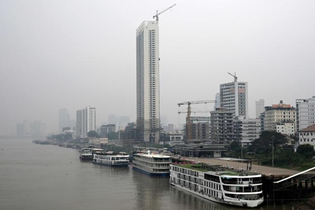 A general view shows heavy air pollution conditions over the Tonle Sap River in Phnom Penh on February 11, 2026. (Photo by TANG CHHIN Sothy / AFP)