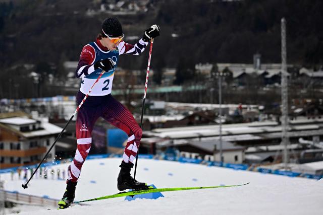 Austria's Thomas Rettenegger competes in the cross-country of the nordic combined individual Gundersen normal hill/10km competition event at Tesero Cross Country Stadium at Lago di Tesero (Val di Fiemme) during the Milano Cortina 2026 Winter Olympic Games on February 11, 2026. (Photo by Tobias SCHWARZ / AFP)