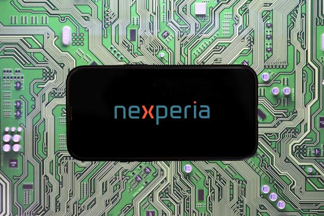 (FILES) This photograph shows the Nexperia logo displayed on a smartphone, in Brussels on November 3, 2025. A Dutch court on February 11, 2026, ordered a formal investigation into alleged mismanagement at Nexperia, a Chinese-owned chip firm at the centre of a global tug-of-war over critical semiconductor technology. (Photo by Nicolas TUCAT / AFP)