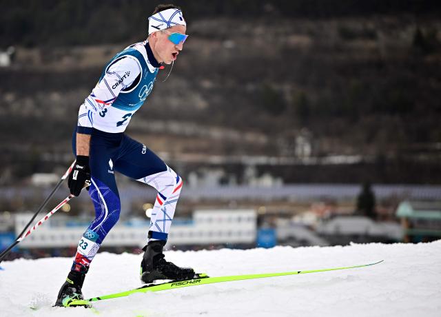 France's Laurent Muhlethaler competes in the cross-country of the nordic combined individual Gundersen normal hill/10km competition event at Tesero Cross Country Stadium at Lago di Tesero (Val di Fiemme) during the Milano Cortina 2026 Winter Olympic Games on February 11, 2026. (Photo by Tobias SCHWARZ / AFP)
