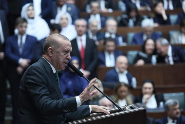 Turkish President and the leader of the Justice and Development Party (AKP) Recep Tayyip Erdogan gestures as he gives a speech during his party's parliamentary group meeting at the Turkish Grand National Assembly in Ankara on February 11, 2025. (Photo by Adem ALTAN / AFP)