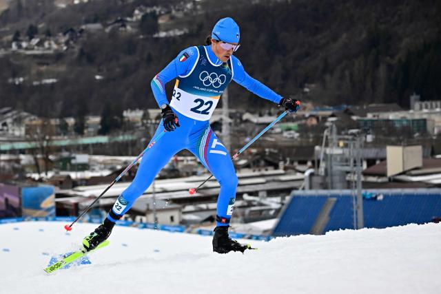Italy's Samuel Costa competes in the cross-country of the nordic combined individual Gundersen normal hill/10km event at Tesero Cross Country Stadium at Lago di Tesero (Val di Fiemme) during the Milano Cortina 2026 Winter Olympic Games on February 11, 2026. (Photo by Tobias SCHWARZ / AFP)