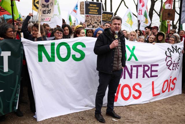President of Medecins du monde Jean-François Corty speaks during a demonstration for agriculture, the environment and health, against the Duplomb law, at the initiative of dozens of NGOs and farmers' organizations, in front of the National Assembly in Paris on February 11, 2026. Senator Laurent Duplomb's law, adopted by Parliament in early July, facilitates water storage and the expansion of livestock buildings. But another measure concentrated indignation: the conditional reintroduction of acetamiprid, a pesticide from the neonicotinoid family banned in France but authorized elsewhere in Europe and accused of being a "bee killer" by its critics. (Photo by Guillaume BAPTISTE / AFP)
