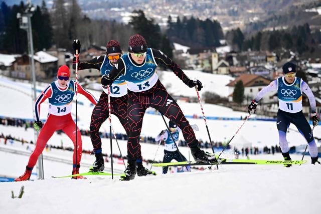 Norway's Andreas Skoglund (L), Germany's Johannes Rydzek, Germany's Julian Schmid and Japan's Akito Watabe compete in the cross-country of the nordic combined individual Gundersen normal hill/10km event at Tesero Cross Country Stadium at Lago di Tesero (Val di Fiemme) during the Milano Cortina 2026 Winter Olympic Games on February 11, 2026. (Photo by Tobias SCHWARZ / AFP)