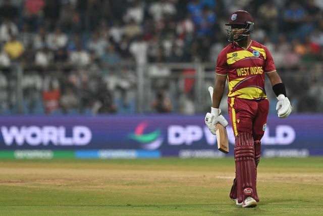 West Indies' captain Shai Hope walks back to the pavilion after his dismissal during the 2026 ICC Men's T20 Cricket World Cup group stage match between England and West Indies at the Wankhede Stadium in Mumbai on February 11, 2026. (Photo by Indranil MUKHERJEE / AFP)