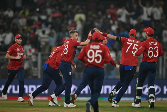 England's Sam Curran (3L) celebrates with teammates after taking the wicket of West Indies' Brandon King during the 2026 ICC Men's T20 Cricket World Cup group stage match between England and West Indies at the Wankhede Stadium in Mumbai on February 11, 2026. (Photo by Indranil MUKHERJEE / AFP)