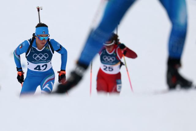 Italy's Dorothea Wierer (L) and Switzerland's Lena Haecki-Gross ski in the women's biathlon 15km individual event during the Milano Cortina 2026 Winter Olympic Games at the Anterselva Biathlon Arena (Sudtirol Arena) in Anterselva (Val Pusteria) on February 11, 2026. (Photo by FRANCK FIFE / AFP)